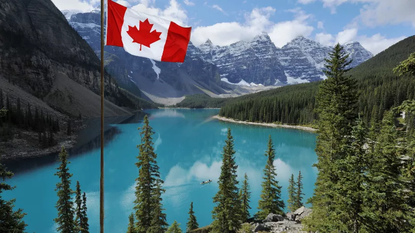 Canadian flag with mountains in the background