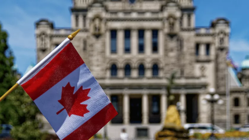 canadian flag infront of a building