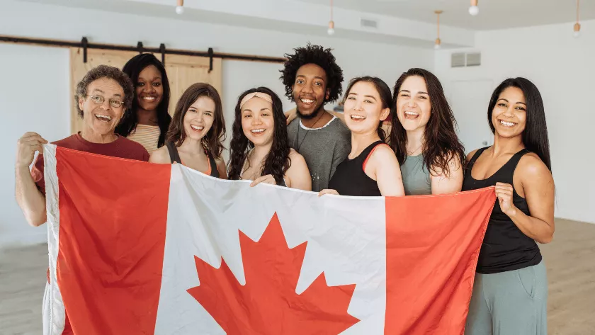 a group of people holding the flag of Canada