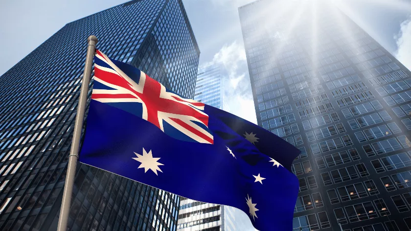 unites stated flag with a building in the background