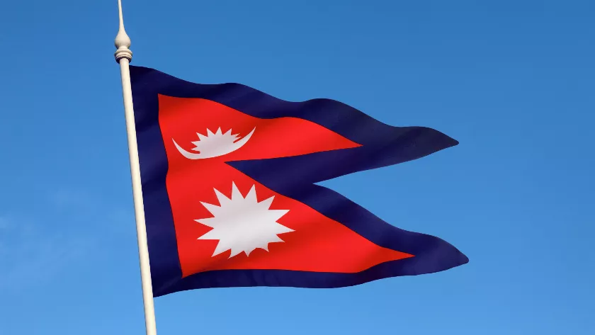 Nepal flag with sky in the background