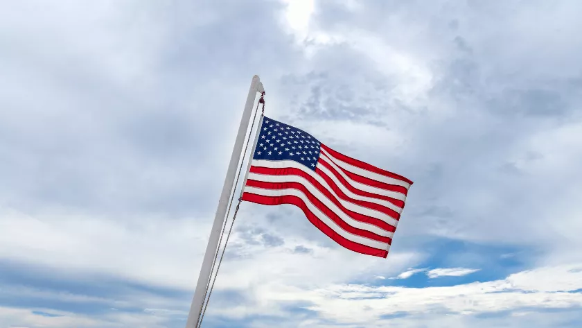 A US flag with sky in background