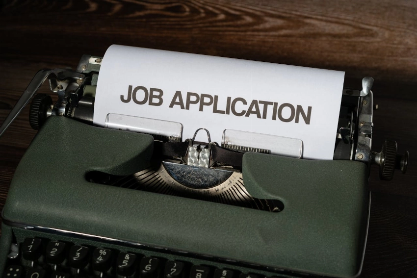 Close-up of a vintage typewriter with a job application paper inserted