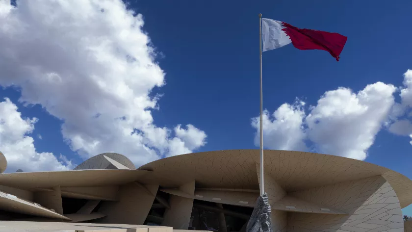 Qatar flag infront of a building