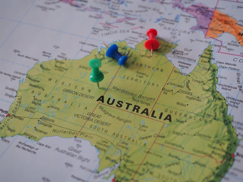 Close-up of a map of Australia featuring colorful pushpins marking locations