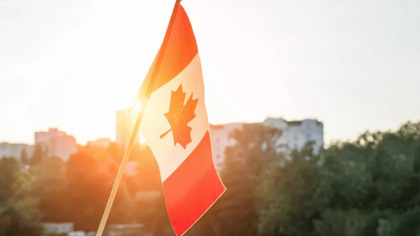 canadian flag with sunlight in the background