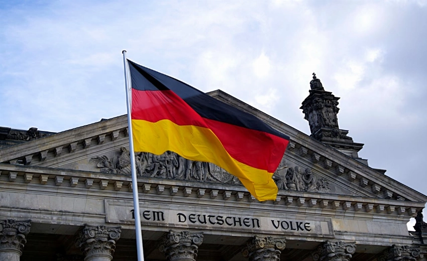 German national flag waving in front of the Reichstag building in Berlin, a symbol of democracy